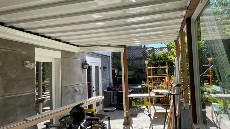 exterior construction project showing a drainage system deck cover and renovated exterior space