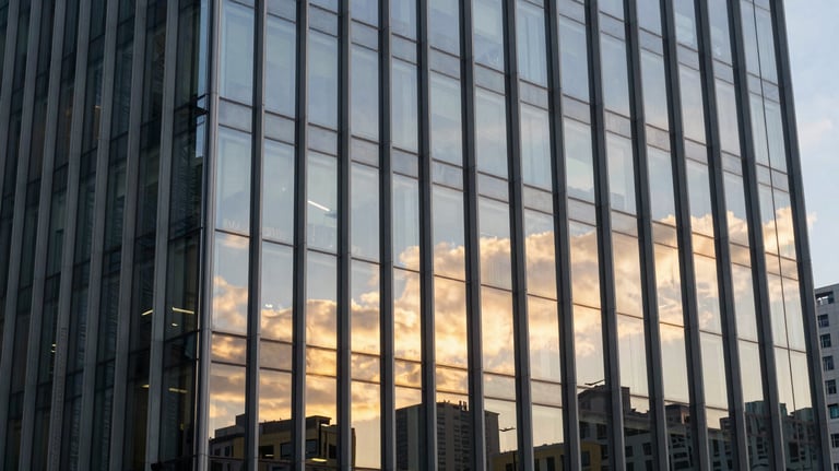 High-end corporate building facade with sleek glass panels reflecting a golden sunset, symbolizing growth and authority. Global / High-end corporate.