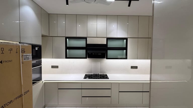 Modern modular kitchen with high-gloss cabinets, white quartz countertops, and built-in appliances.