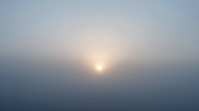 A minimalist scene of a sun rising through morning mist, symbolizing the start of a circadian-aligned day. Colors #F0F5F7 and #AABEC6 dominant.