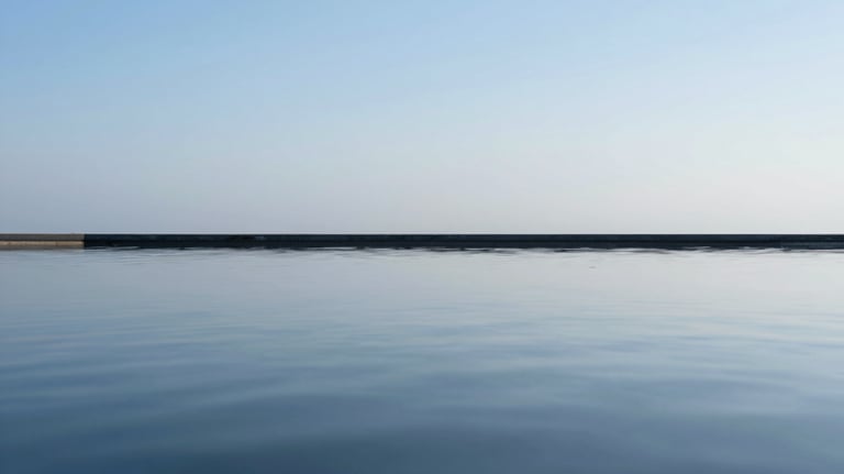 Abstract conceptual image representing mental clarity: a still pool of water reflecting a clear sky, clean lines, and a peaceful professional mood using #A7C2BF.