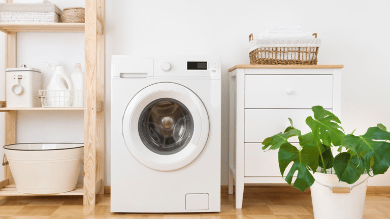 a dog is sitting in front of a washer