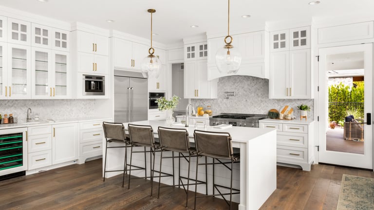 a kitchen with a large island and a bar stool