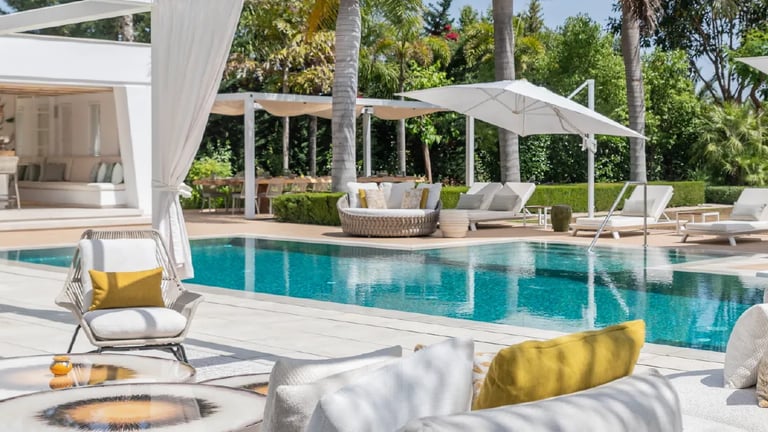 Villa Serenity poolside with daybeds and chic white pergola