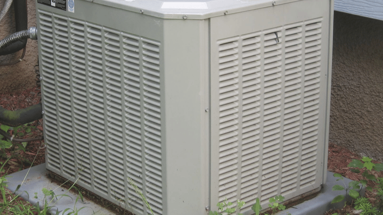 a small air conditioner sitting on a stone block