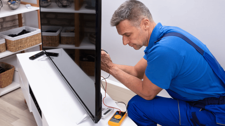 a man in a blue shirt is looking at a television