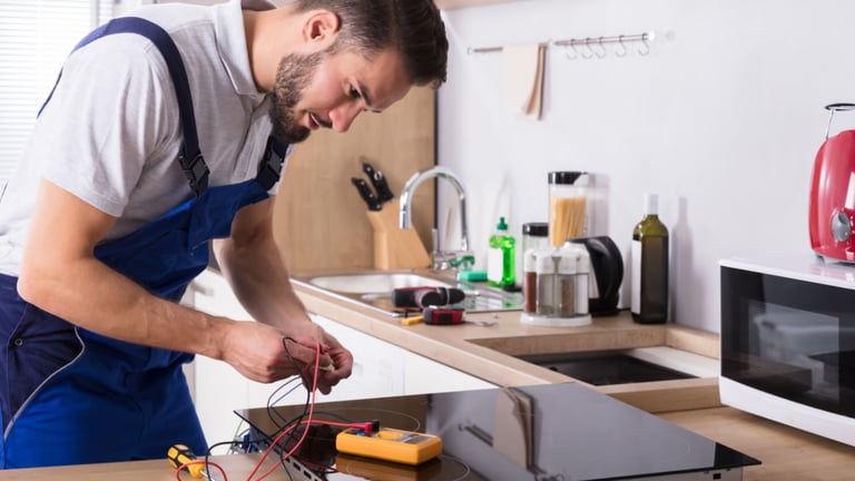a man in a blue apron is working on a kitchen counter