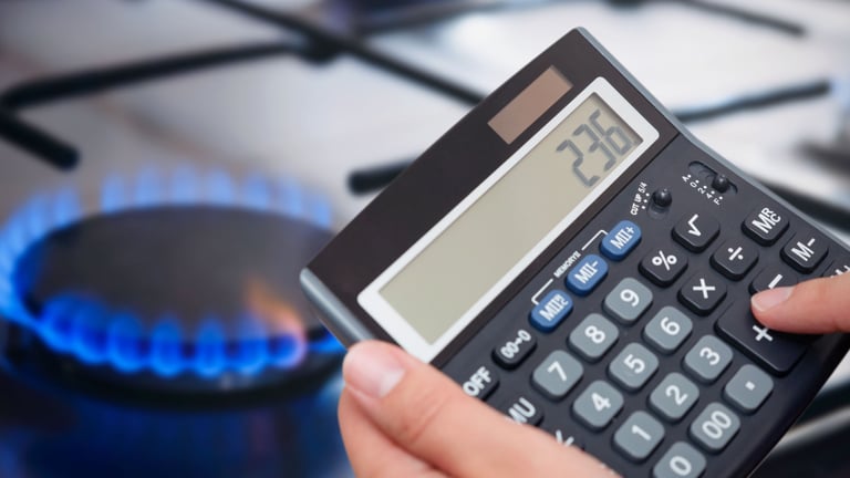 a person holding a calculator and a calculator