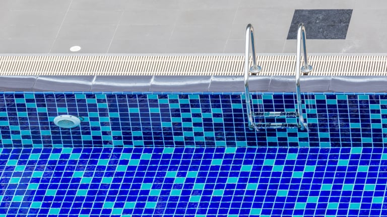 a pool with a blue tiled pool and a swimming pool