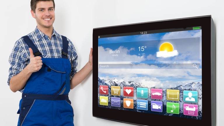 a man in overalls and overalls standing in front of a television screen