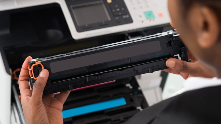 a person holding a printer and a printer