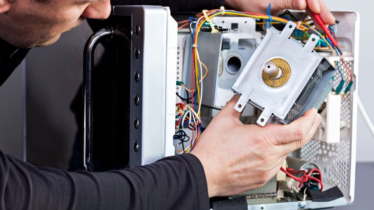 a man is fixing a computer monitor in a computer