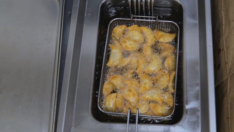 a fryer with potatoes in a fryer