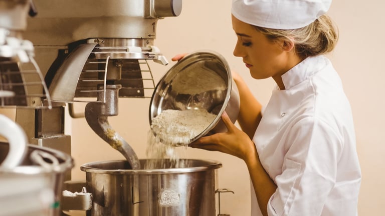 a woman in a chef's hat is pouring flour into a potted pot