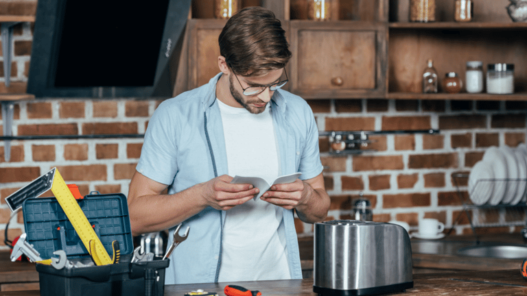 a man in a blue shirt is looking at his phone