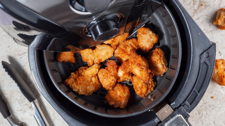a fryer with chicken nuggling in it