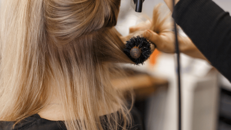 a woman is getting her hair styled with a hairdoodle