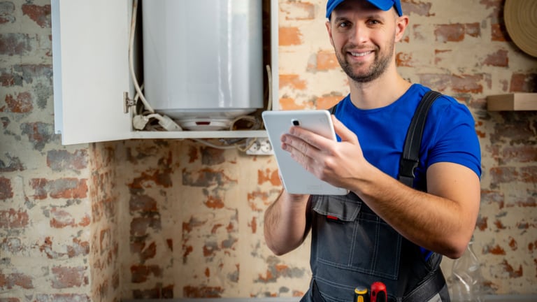 a man in a blue shirt and a tablet computer
