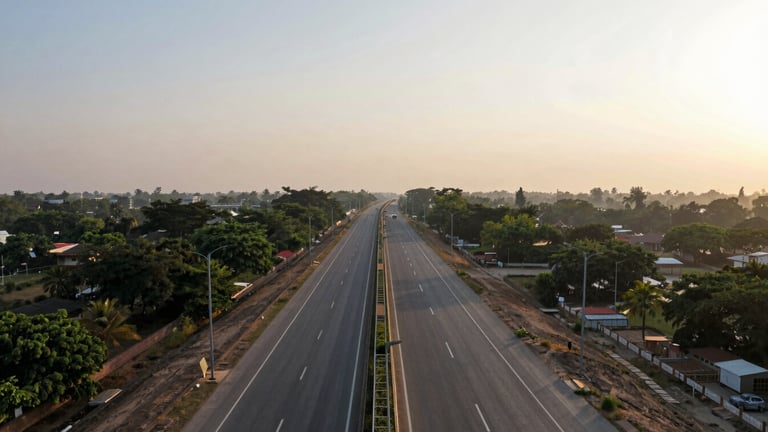 Wide panoramic aerial shot of the Delhi-Mumbai Expressway corridor near Faridabad, warm late afternoon sun, clear roads, green buffer zones, 35mm.