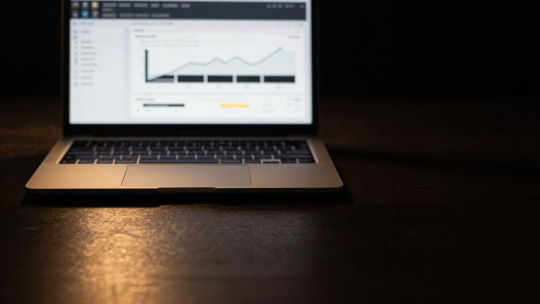 Minimalist workspace, high-end laptop displaying clean analytical charts, abstract golden light reflections on dark metallic surfaces, low-key lighting, high-contrast, warm golden highlights, macro close-up, 35mm lens