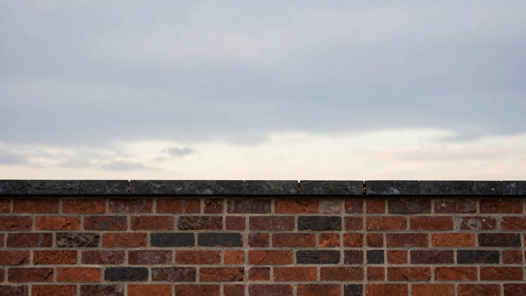 Wide panoramic view of a newly repaired chimney crown against an expansive, dramatic New England sky at dusk, low horizon, focus on the clean lines of the masonry.