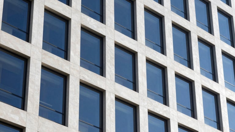 Crisp, architectural shot of a modern, high-end office building exterior in Eagle, Idaho, under cool daylight. Focus on clean lines and reflective surfaces. No people, no text.