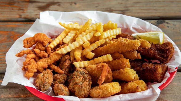 Captain’s Combo Platter Meal with fried fish, clams, oysters, shrimp, calamari, and crinkle‑cut fries from Captain’s Galley