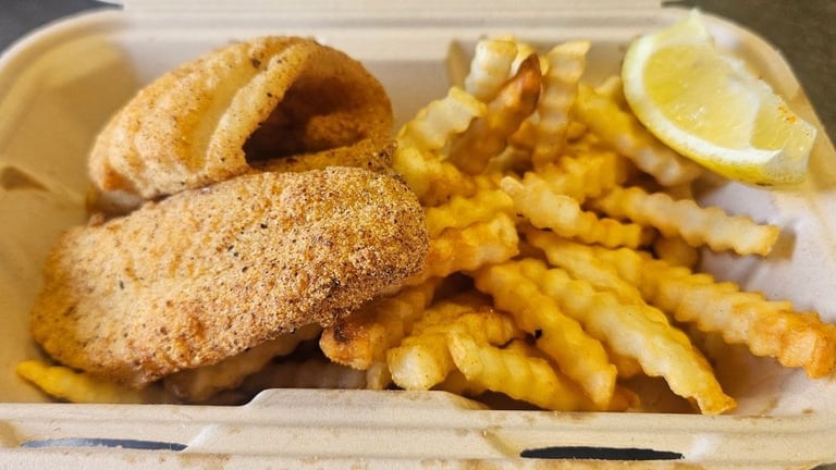 Lighter portion fried catfish meal with crispy crinkle cut fries at Captain's Galley