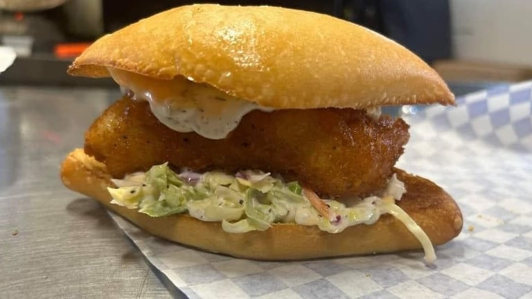 Fried fish sandwich with coleslaw and tartar sauce on a toasted bun from Captain’s Galley