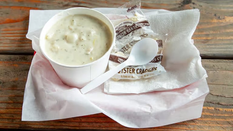 Clam chowder cup with potatoes and herbs served with oyster crackers from Captain’s Galley.
