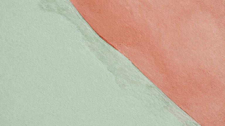 Extreme close-up of a mural detail, showing delicate watercolor layers of diluted terracotta and sage green on a textured eggshell wall, soft natural light