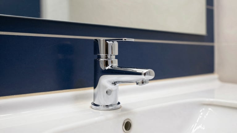 Close-up of a pristine, polished chrome fixture in a high-end corporate restroom, reflecting clean architectural lines and soft lighting, bright natural daylight, sharp focus, 35mm
