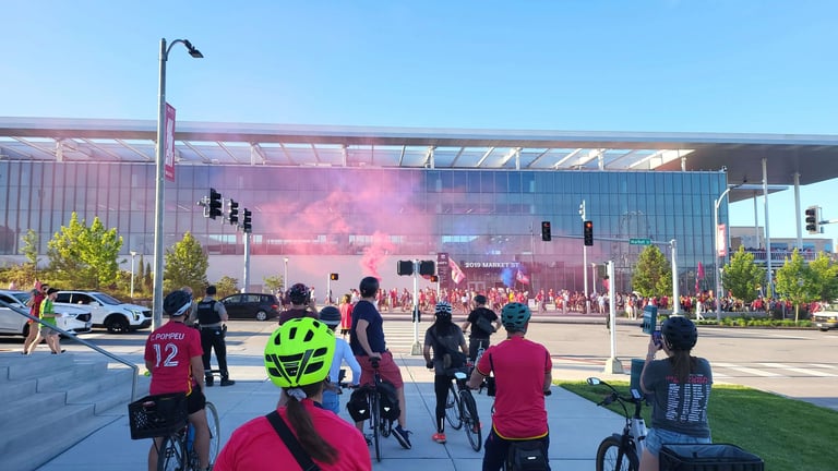 Large shot of a biking event with pink smoke in the air