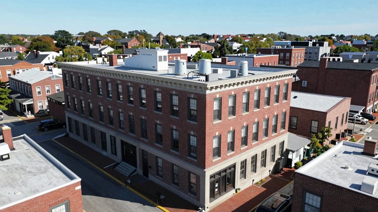 Wide aerial view of 116 Center St, Pembroke, MA 02359, showing the building and surrounding area, under bright natural daylight, crisp focus.