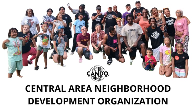 Diverse group of community members posing for the Central Area Neighborhood Development Organization CANDO.