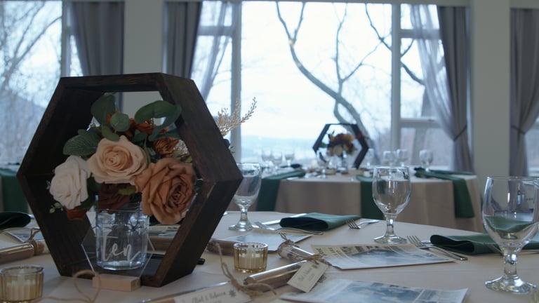 Color graded picture of a table with a vase of flowers and wine glasses