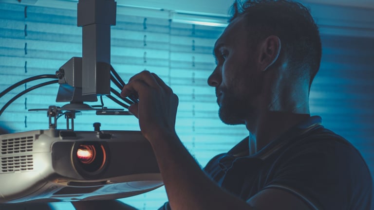 a man in a black shirt is holding a projector