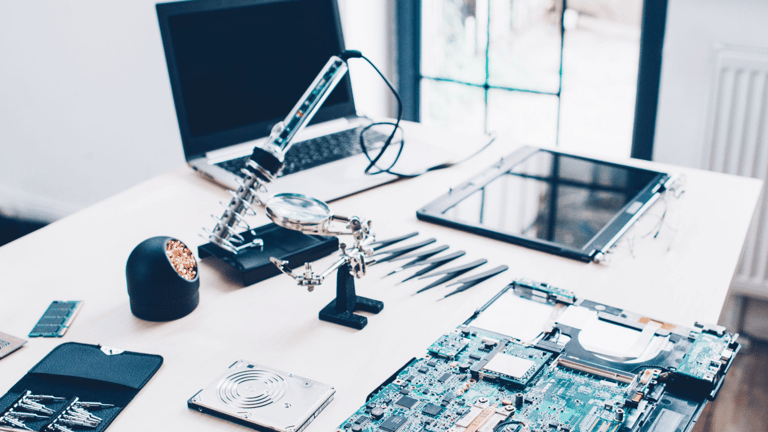 a laptop computer sitting on a desk with a laptop and a laptop