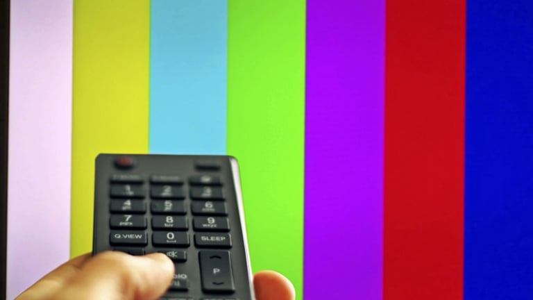 a person holding a remote control control