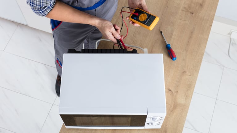 a man in a blue apron and a white shirt is holding a multimetered