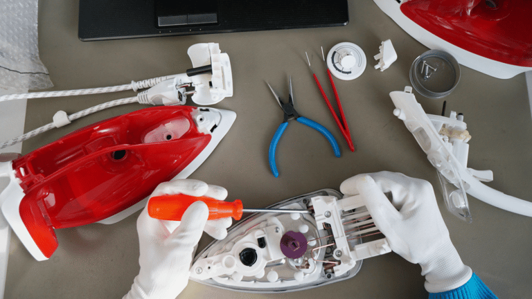 a person's hands holding a red object