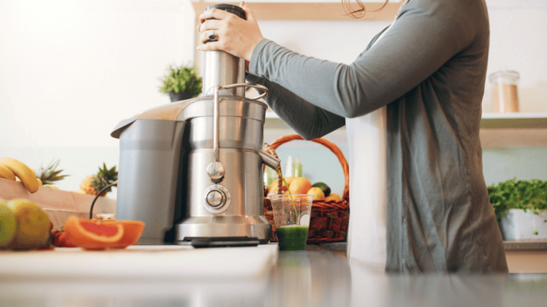 a woman is holding a juicer in her hand