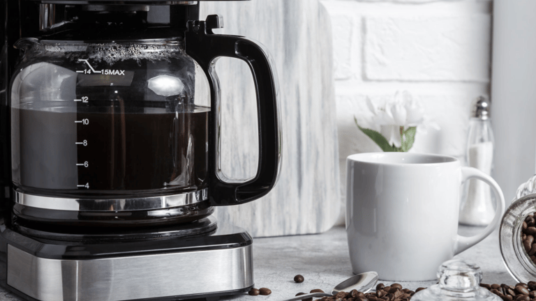 a coffee maker with coffee beans and coffee beans