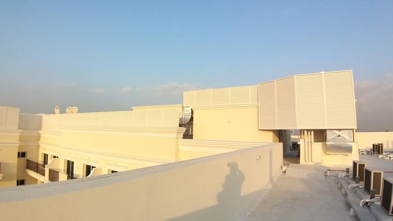 Decorative aluminum louvered enclosure for rooftop chiller units and water tanks.