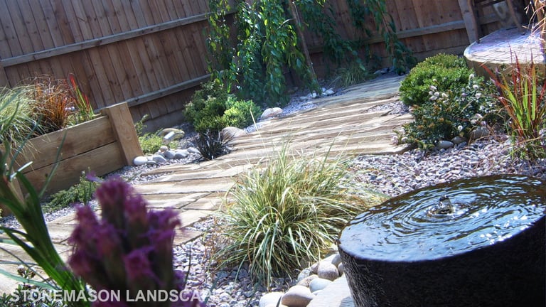 Rustic driftwood beach effect small garden with water feature