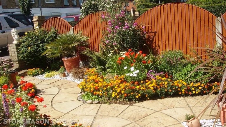 Curvey winding path, circle kits paving slabs weaving through lots of beautiful plants & flowers