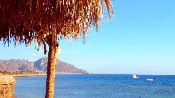 a boat in the water near a beach in Egypt