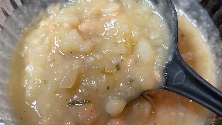 Potato Soup, when copleted, with large serving spoon starting to lift out of dish. For FlavorfulBites