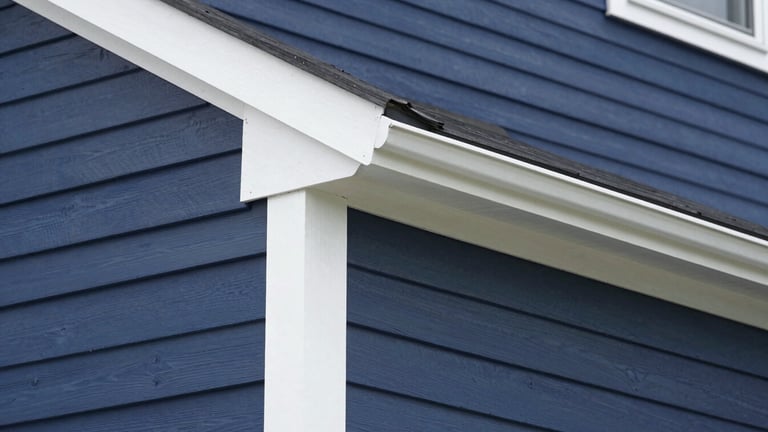 Crisp documentary shot of a freshly painted home exterior, clean white trim against deep navy siding, sharp focus, 35mm lens