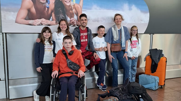 a group of people standing around a group of luggage